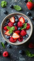 Colorful chia seed pudding topped with fresh berries and mint for a healthy dessert photo