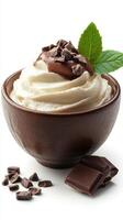Creamy dessert topped with chocolate and mint in an elegant bowl against a white background photo