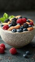 Delicious bowl of mixed berries and nuts served on a dark background in a textured bowl photo