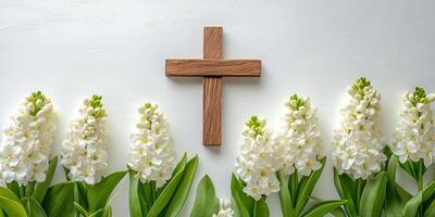 White flowers arranged around a wooden cross on a light background for a peaceful display in a serene setting photo