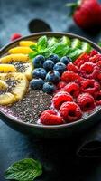 Colorful smoothie bowl topped with fresh fruits and chia seeds during a sunny breakfast photo