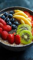 Colorful fruit bowl with strawberries, blueberries, mango, kiwi, and chia seeds served as a healthy breakfast option photo