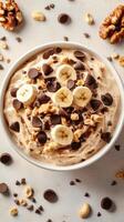 Creamy banana dessert with chocolate chips and walnuts prepared in a kitchen setting photo