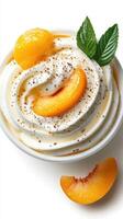 Creamy dessert topped with peach slices and mint leaves, perfect for summer indulgence photo