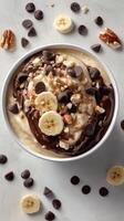 Delicious bowl of banana pudding topped with chocolate, nuts, and chips for a delightful treat photo