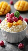 Delicious bowl of creamy rice pudding topped with fresh raspberries and mango slices in a cozy kitchen setting photo