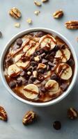 Delicious bowl of chocolate banana oatmeal topped with nuts and chocolate chips in a cozy kitchen setting photo