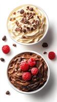 Delight in two flavors of creamy dessert topped with chocolate and fresh raspberries on a clean background photo