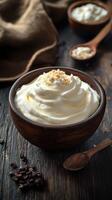 Whipped cream topped with coconut flakes in a rustic wooden bowl with coffee beans and spoons in a cozy kitchen setting photo