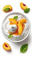 Creamy dessert topped with fresh peach slices and mint leaves on a white background photo
