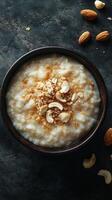 Creamy rice pudding topped with nuts and a sprinkle of sweetness in a rustic bowl photo
