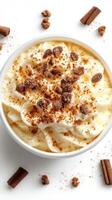 Creamy dessert topped with whipped cream, spices, and cookie crumbles in a bowl on a light background photo