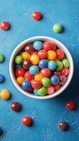 Colorful candy bowl filled with assorted jelly sweets on a vibrant blue background photo