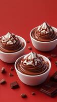 Delicious chocolate mousse topped with whipped cream and chocolate sauce on a vibrant red background photo
