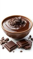 Rich chocolate melting in a bowl with chunks and shavings on top, perfect for dessert preparation or topping photo