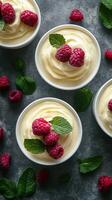 Delightful raspberry dessert served in bowls with fresh mint leaves on a textured surface photo