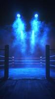 Blue spotlight illuminates an empty boxing ring in a darkened arena ready for an exciting match to begin photo