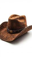 Brown cowboy hat with intricate detailing and a stylish band on a clean background photo
