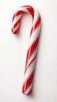 Red and white striped candy cane displayed on a light background for festive season decor and treats photo