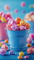Colorful meringue candies in buckets on a bright blue background creating a festive atmosphere in a dessert display photo
