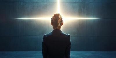 Individual contemplates bright light in dark space during a moment of introspection and realization photo