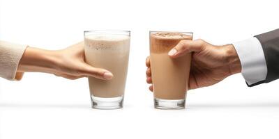 Two hands exchanging glasses of brown beverages in a minimalist setting photo