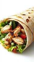 Chicken wrap filled with fresh vegetables and herbs served in a toasted tortilla photo
