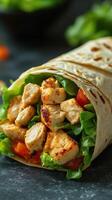 Fresh chicken wrap filled with lettuce and tomatoes ready to serve at a casual dining setting photo