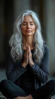 Woman meditating in a serene indoor space with natural light and tranquil ambiance photo