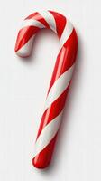 Classic red and white candy cane against a light background perfect for holiday celebrations and festive decorations photo