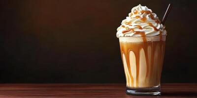 Rich caramel cream dessert drink served in a tall glass with a straw on a wooden table in a dim setting photo