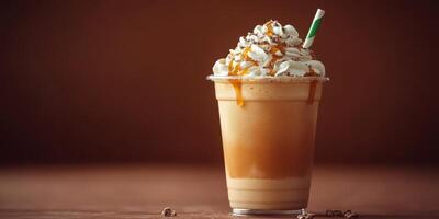 Delicious caramel whipped cream drink served in a clear cup with a green straw on a wooden table backdrop photo
