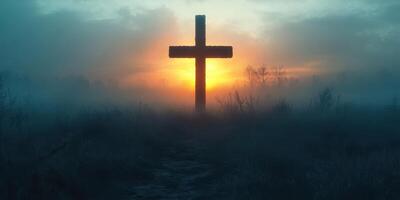Cross stands in foggy field during sunrise, creating a serene atmosphere of reflection and peace photo