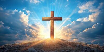 Wooden cross on a hilltop with radiant sunbeams shining through clouds at dawn photo