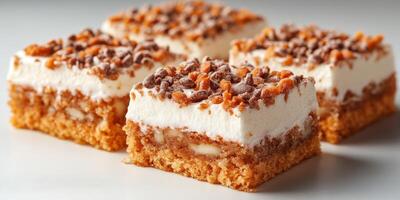 Delicious dessert squares with layers of cream, cake, and crunchy toppings enjoyed at a summer gathering photo
