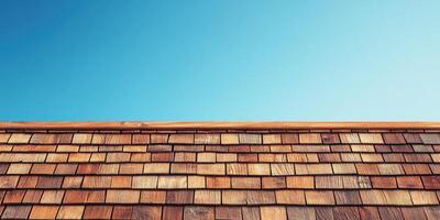 Wooden roof with clear blue sky at midday highlights craftsmanship and natural materials photo