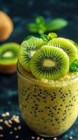 Refreshing kiwi smoothie topped with fresh fruit and mint on a dark background during afternoon light photo