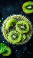 Healthy kiwi smoothie with chia seeds served in a glass on a dark background photo
