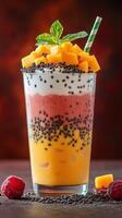 Colorful layered fruit smoothie with fresh mango and raspberry on a dark background photo