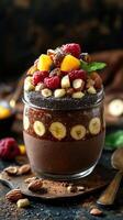 Delicious chocolate chia pudding topped with fresh fruit and nuts in a jar photo