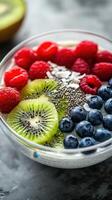 Brightly colored fruit bowl with chia seeds and creamy yogurt served for breakfast in a modern kitchen photo