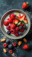 Healthy breakfast bowl with fresh berries and almonds presented on a dark surface photo