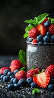 Fresh berries and chia seeds arranged in a jar with mint leaves for a healthy dessert idea photo
