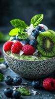 Healthy fruit bowl with raspberries, blueberries, kiwi, and coconut served on a textured surface photo