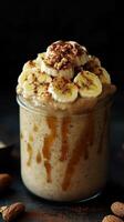 Delicious banana smoothie topped with sliced bananas, nuts, and a drizzle of syrup for a nutritious treat photo