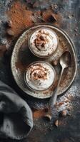 Sweet dessert with whipped cream and cocoa served on a rustic plate beside a silver spoon in a cozy setting photo