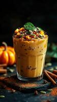 Creamy pumpkin smoothie topped with nuts and spices, served in a glass with seasonal decorations during autumn photo