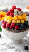 Colorful fruit bowl filled with chia seeds and fresh berries in a bright kitchen setting photo