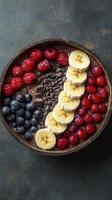 Colorful dessert bowl featuring fresh fruits and chocolate in an artistic arrangement on a textured background photo