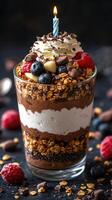 Delicious chocolate parfait with fresh berries and a birthday candle in a festive setting photo